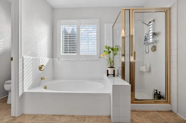 a white bath tub sitting next to a small bathroom