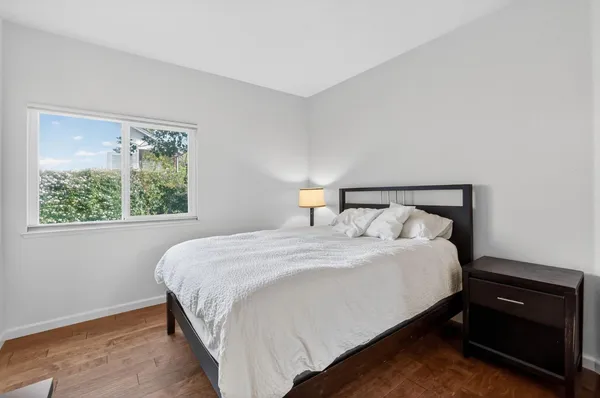 a bedroom with a bed and window