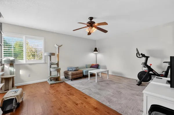 a living room with furniture a window and gym equipment