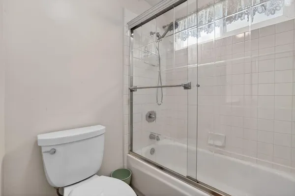 a bathroom with a toilet and a bathtub