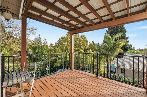 a view of balcony with wooden floor and fence