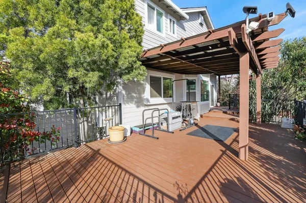 a view of patio with a table and chairs and potted plants