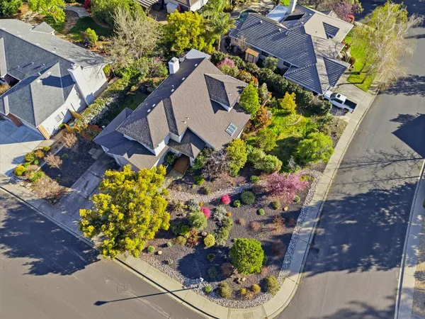 a view of a house with a yard and street