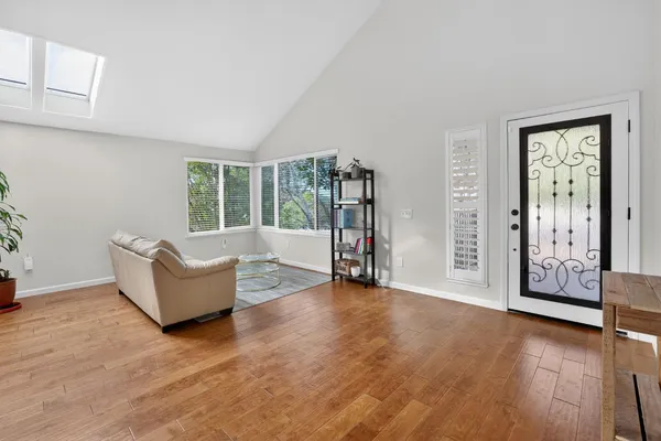 a living room with furniture and wooden floor