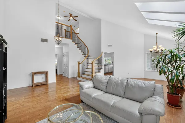 a living room with furniture and a wooden floor