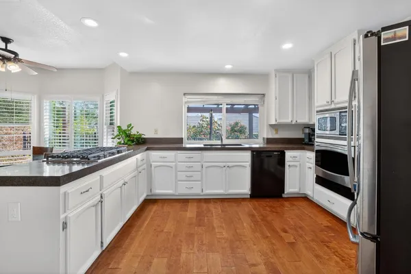 a kitchen with a sink stove and white cabinets
