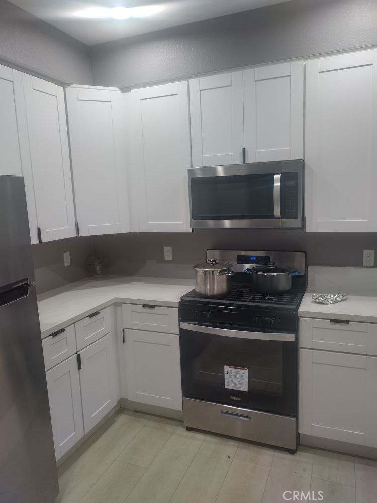 a stove top oven sitting inside of a kitchen