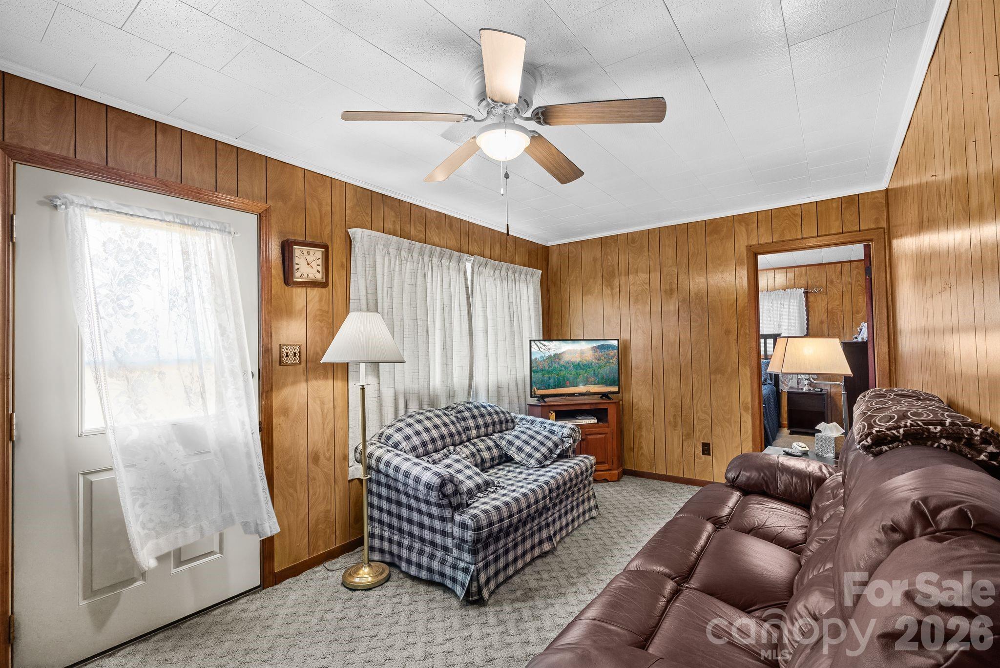 148 Monteith Road Brevard, NC 28712 - Photo 11 of 39 a living room with furniture and a chandelier