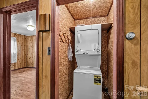 a view of a hallway with wooden floor and windows