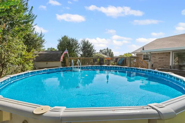 a view of a swimming pool with a yard