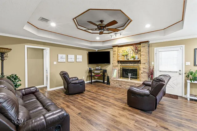 a living room with furniture a fireplace and a flat screen tv