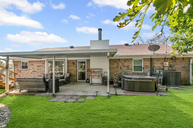 a front view of a house with a garden and patio