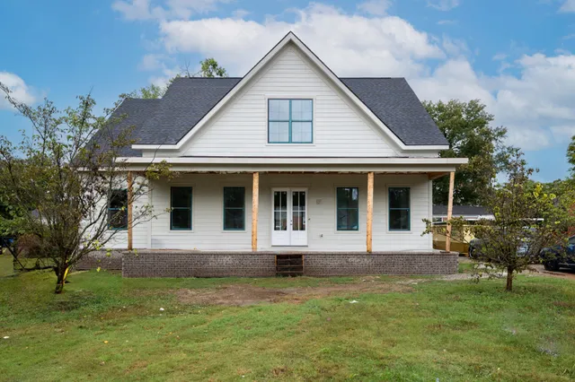 a front view of a house with garden