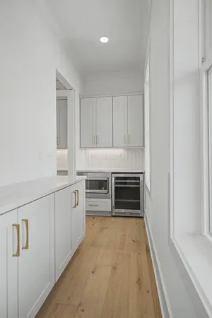 a kitchen with granite countertop white cabinets and stainless steel appliances