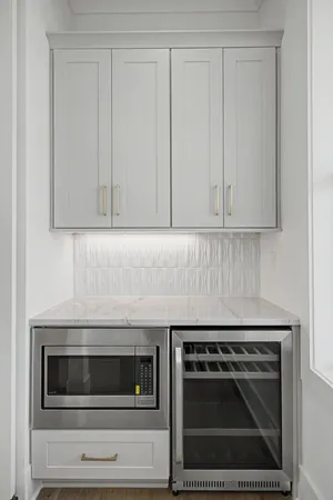 a kitchen with granite countertop white cabinets and stainless steel appliances
