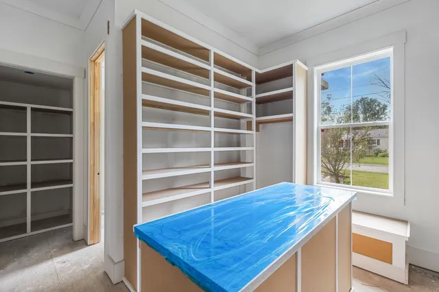 a view of storage and utility room with windows