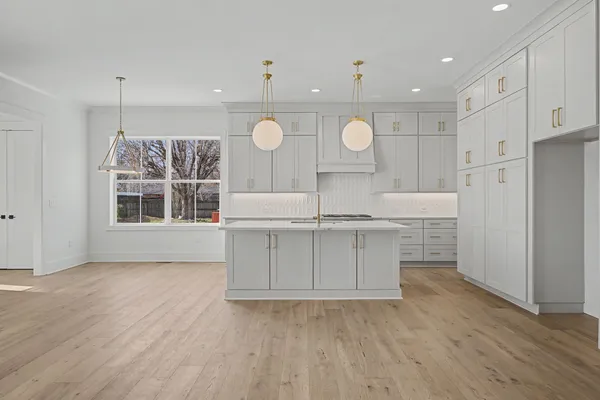 a view of a kitchen with a sink stainless steel appliances and cabinets