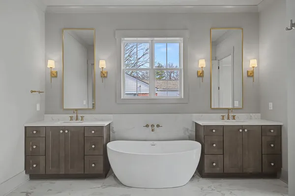 a spacious bathroom with a bathtub sink and mirror