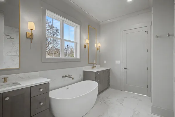 a kitchen with a chandelier stainless steel appliances granite countertop a stove a sink and a window