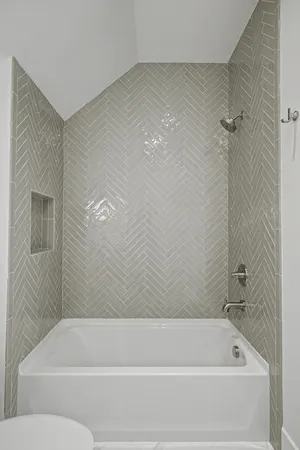 a bathroom with a granite countertop toilet a sink and bathtub