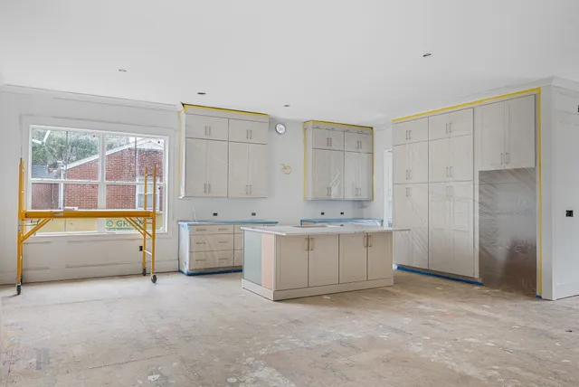 a spacious bathroom with a tub sink and mirror