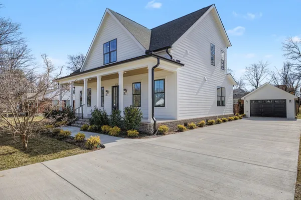 a view of a livingroom with wooden floor and a chandelier