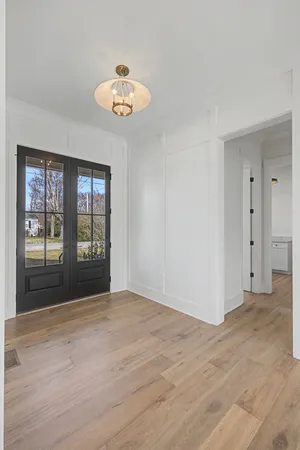 an empty room with fan and windows