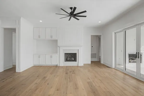 a large kitchen with stainless steel appliances a large counter top a sink a stove and a refrigerator