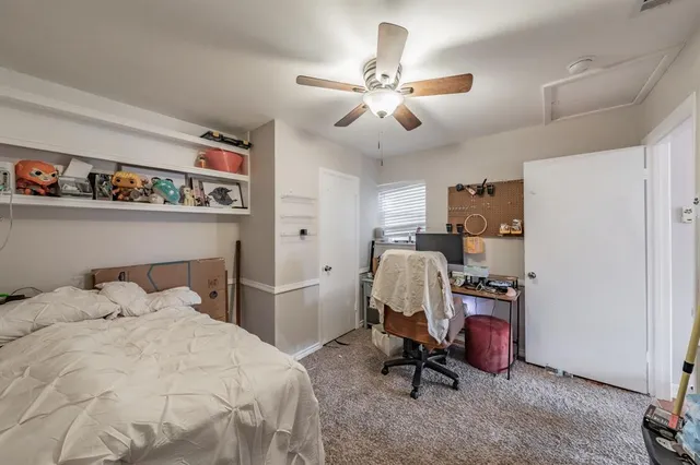 a bedroom with a bed and a desk