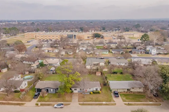 an aerial view of residential building and green space