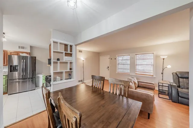 a view of a dining room with furniture and wooden floor