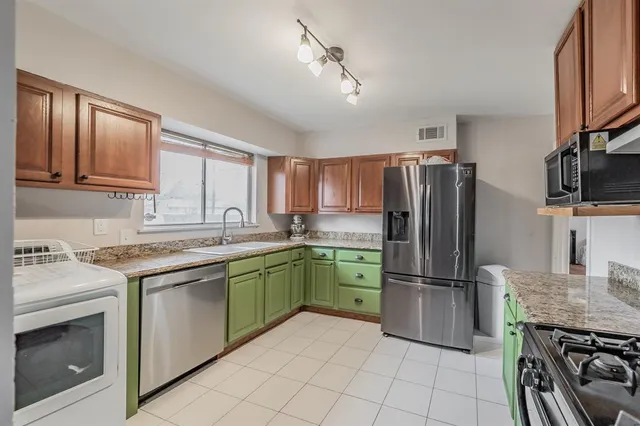 a kitchen with a refrigerator stove and sink