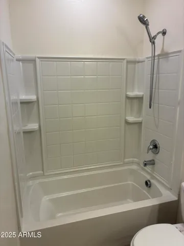 a bathroom with a bathtub and toilet