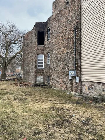 a view of a yard with wooden fence