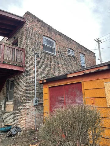 a view of a door and brick wall