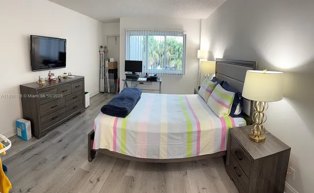 a bed room with a bed window and a chair