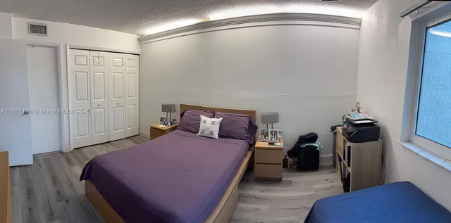 a bedroom with a bed and a walk in closet