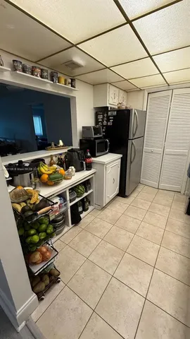 a kitchen with stainless steel appliances kitchen island granite countertop a stove and a refrigerator