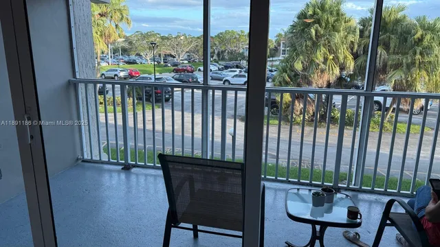 a balcony with table and chairs