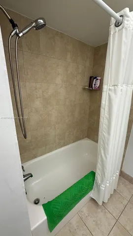 a bathroom with a shower and a tub