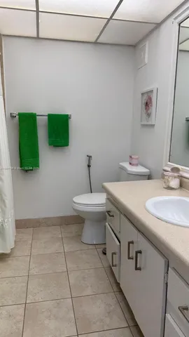 a bathroom with a sink a toilet and mirror