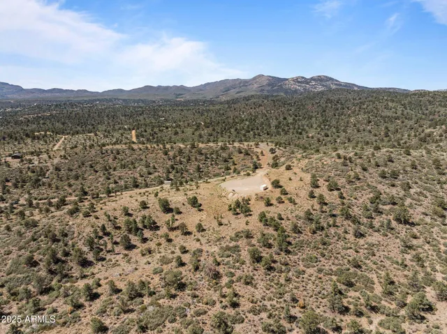 a view of mountain with sunset in background