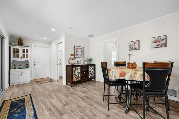 a view of a dining room with furniture and wooden floor