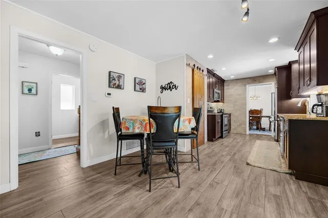 a view of a dining room with furniture and wooden floor