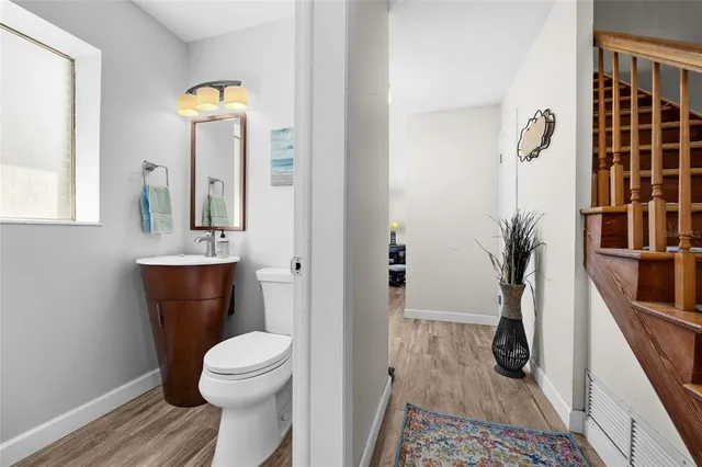 a bathroom with a toilet a sink and mirror