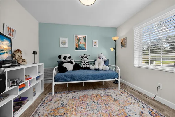 a living room with furniture and a book shelf