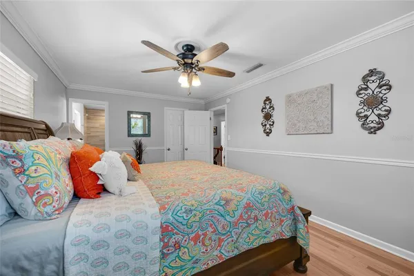a bedroom with a bed and a chandelier