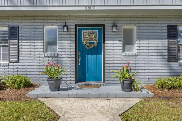 a view of house with potted plants