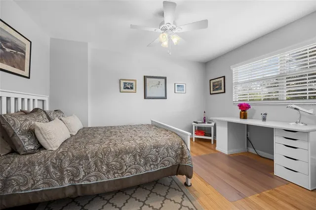 a bedroom with a bed and a desk