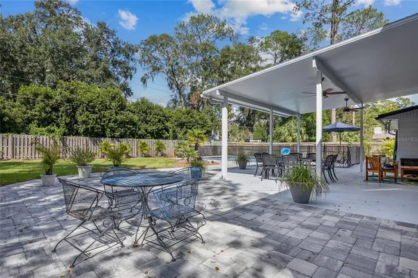 a view of a patio with table and chairs and potted plants